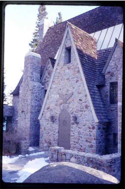 Archival slide of a stone outbuilding in winter