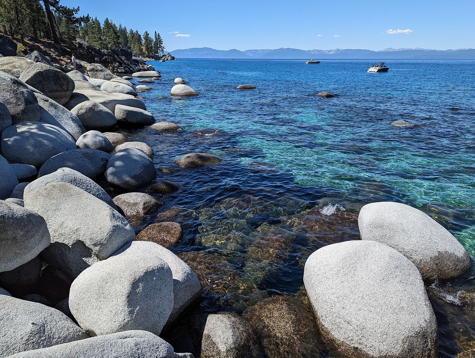 Granite boulders in clear water along the estate shoreline